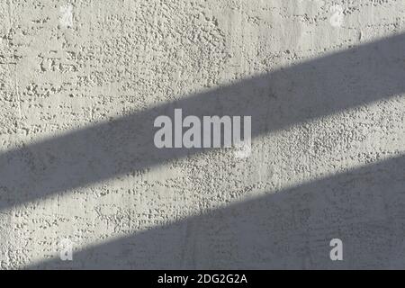 Shadows on the gray concrete wall from the sun. Shadow background. Stock Photo