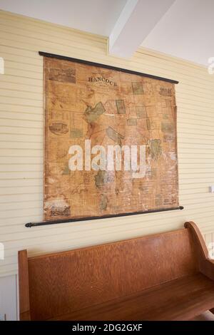 An old wall map of local Hancock County hangs at the restored Surry Village School. In Surry, Maine. Stock Photo