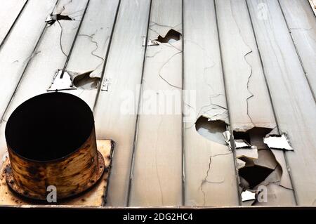 Broken glass and ventilation fan on abandoned industrial building Stock Photo