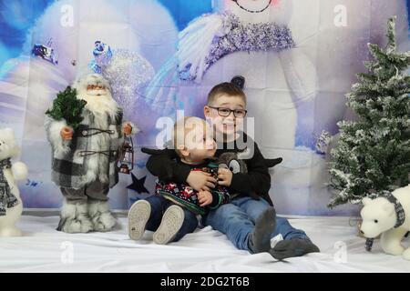 A traditional happy family Christmas photoshoot with a Christmas backdrop Stock Photo