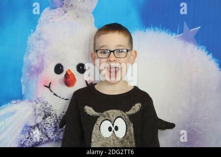 A traditional happy family Christmas photoshoot with a Christmas backdrop Stock Photo