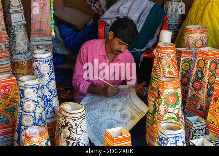 Artist in Shilparamam Hyderabad Telangana India painting beautiful floral patterns on lamp shades on tough paper and canvas and fabric Stock Photo