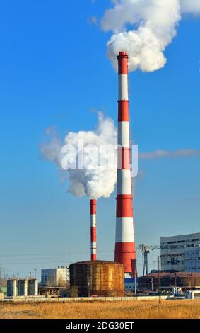 Industrial pipes with emission of a smoke (environmental problem) Stock Photo