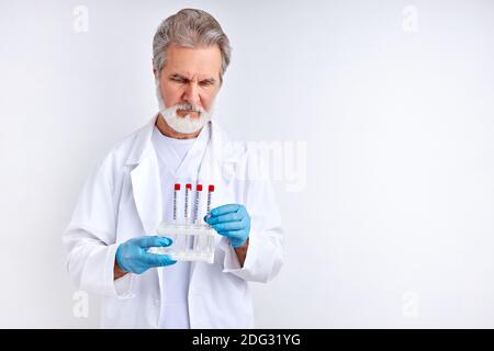 doctor examining, studying the coronavirus tests in tube, make analysis. isolated over white background Stock Photo