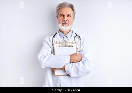 serious caucasian doctor man posing at camera holding tablet in hands, confidently looking at camera. isolated Stock Photo