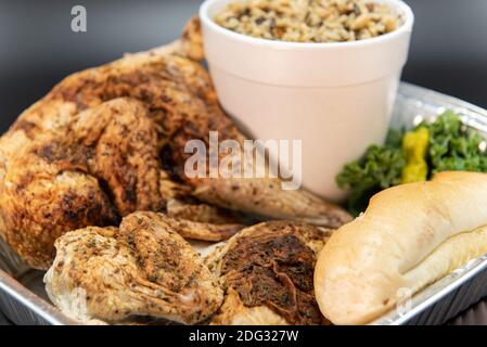 Fresh off the grill whole roasted chicken with large side of mashed potatoes and bread to feed your whole family. Stock Photo
