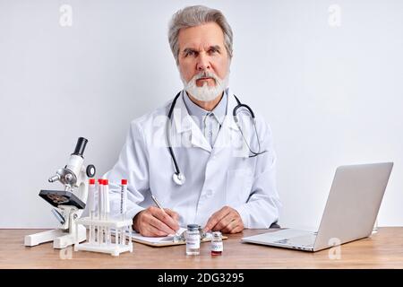 senior doctor makes research, using tube tests in laboratory. corona virus pandemic concept.coronavirus vaccine development Stock Photo