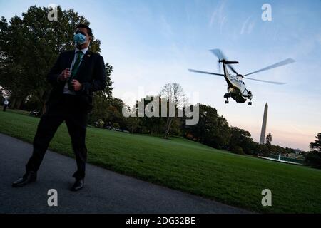 A U.S. Secret Service Agent stands guard as Marine One, carrying U.S. President Donald Trump departs the White House in Washington, DC, USA, 20 October 2020. Trump is scheduled to host a campaign rally in Erie, Pennsylvania before returning to the White House tonight. Credit: Alex Edelman/The Photo Access Stock Photo