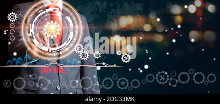 Businessman touching brain in cogwheel. Optimisation of construction. Industry 4.0. Mixed media Stock Photo