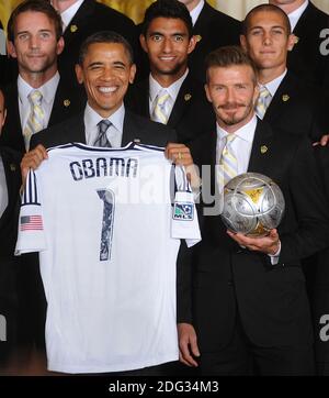 U.S. President Barack Obama holds up a jersey given to him by LA Galaxy while welcoming members of the Major League Soccer champions including David Beckham (R) to the White House to honor their 2012 season and their MLS Cup victory in the East Room of the White House in Washington, DC, USA on May 15 2012. Photo by Olivier Douliery/ABACAPRESS.COM Stock Photo