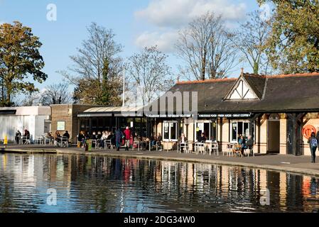 Lakeside Café with people outside at tables seen across boating lake Alexandra Palace Park, London Borough of Haringey Stock Photo