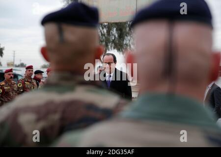 French President Francois Hollande inspects a group of French soldiers at the Iraqi Counter Terrorism Service Academy on the Baghdad Airport Complex in Baghdad, Iraq, Monday, January 2, 2017. Hollande is in Iraq for a one-day visit. The soldiers are part of a task force to assess and advise Iraqi security forces under the command of international military instructors. Photo by Christophe Ena/Pool/ABACAPRESS.COM Stock Photo