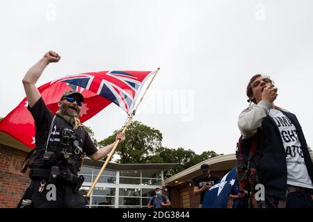 South Yarra, Australia, 5 December, 2020. A man chants as he holds up a flag during the Sack Daniel Andrews Protest in Fawkner Park. Parts of the community are looking to hold the Victorian Premier accountable for the failings of his government that led to more than 800 deaths during the Coronavirus crisis. Victoria has recorded 36 days Covid free as pressure mounts on the Premier Daniel Andrews to relax all remaining restrictions. Credit: Dave Hewison/Alamy Live News Stock Photo