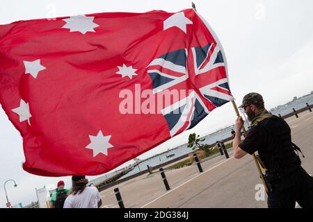 South Yarra, Australia, 5 December, 2020. An upside down Red Ensign flies in the wind during the Sack Daniel Andrews Protest in St Kilda. Parts of the community are looking to hold the Victorian Premier accountable for the failings of his government that led to more than 800 deaths during the Coronavirus crisis. Victoria has recorded 36 days Covid free as pressure mounts on the Premier Daniel Andrews to relax all remaining restrictions. Credit: Dave Hewison/Alamy Live News Stock Photo