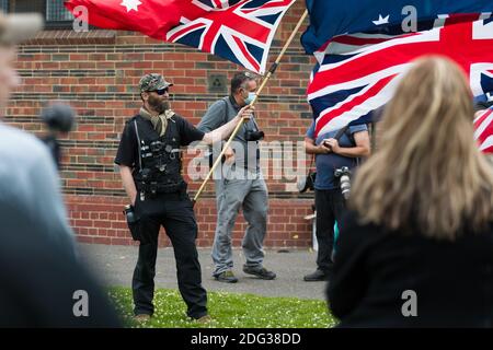 South Yarra, Australia, 5 December, 2020. A man holds an up turned Red Ensign during the Sack Daniel Andrews Protest in Fawkner Park. Parts of the community are looking to hold the Victorian Premier accountable for the failings of his government that led to more than 800 deaths during the Coronavirus crisis. Victoria has recorded 36 days Covid free as pressure mounts on the Premier Daniel Andrews to relax all remaining restrictions. Credit: Dave Hewison/Alamy Live News Stock Photo