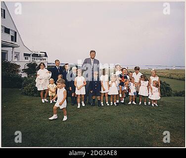 Hyannisport, MA, - Hyannisport Weekend August 3, 1963 -- President Kennedy with children. Kathleen Kennedy (holding Christopher Kennedy) Edward Kennedy Jr., Joseph P. Kennedy II, Kara Kennedy, Robert F. Kennedy Jr., David Kennedy, Caroline Kennedy, President Kennedy, Michael Kennedy, Courtney Kennedy, Kerry Kennedy, Bobby Shriver (holding Timothy Shriver), Maria Shriver, Steve Smith Jr., Willie Smith, Christopher Lawford, Victoria Lawford, Sidney Lawford, Robin Lawford (in foreground- John F. Kennedy Jr.) Photo by Cecil Stoughton - The White House via CNP Stock Photo