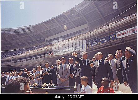 United States President John F. Kennedy attends the 32nd All-Star Baseball Game at D.C. Stadium and throws out the first ball on July 10, 1962. Pictured VIPs include: Speaker of the U.S. House John W. McCormack (Democrat of Massachusetts), Dave Powers, Vice President Lyndon B. Johnson, President Kennedy, Commisioner of Baseball Ford. C. Frick, Lawrence O'Brien, others (in foreground- Dennis Marcel, Frank Brown, members of the Washington Boys Club ). Photo by Cecil Stoughton / The White House via CNP Stock Photo