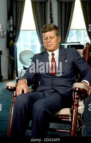 Washington, DC, USA, - Undated File Photo c. 1963 -- United States President John F. Kennedy sits in his rocking chair in the Oval Office of the White House in Washington, DC, USA. Photo by Arnie Sachs - CNP Stock Photo