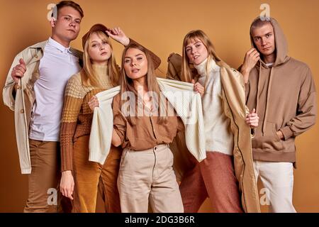 portrait of cool caucasian youth wearing trendy clothes outfit, fashionable men and women in stylish wear, models, posing at camera Stock Photo