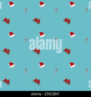seamless pattern Santa hat, bow and candy cane candy cane on blue background Stock Photo