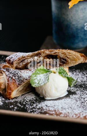 various desserts with tea on a black background Stock Photo