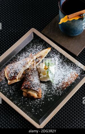various desserts with tea on a black background Stock Photo