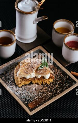 various desserts with tea on a black background Stock Photo