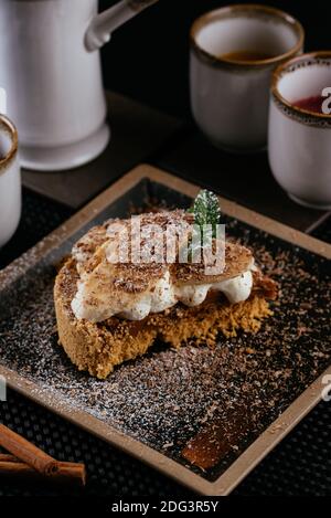 various desserts with tea on a black background Stock Photo