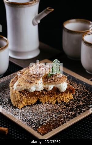 various desserts with tea on a black background Stock Photo