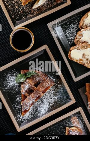 various desserts with tea on a black background Stock Photo