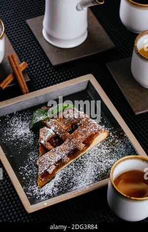 various desserts with tea on a black background Stock Photo