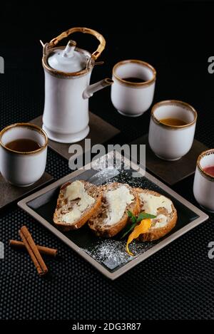 various desserts with tea on a black background Stock Photo