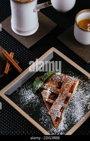 various desserts with tea on a black background Stock Photo