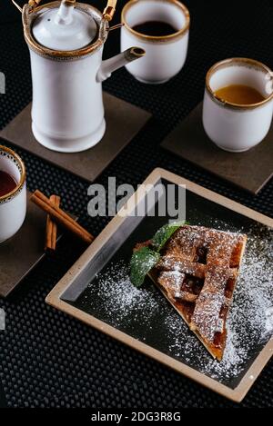 various desserts with tea on a black background Stock Photo