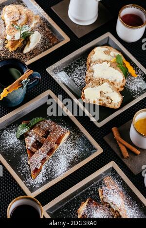 various desserts with tea on a black background Stock Photo
