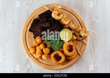 beer snacks on a wooden Board and light background Stock Photo