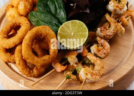 beer snacks on a wooden Board and light background Stock Photo