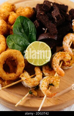 beer snacks on a wooden Board and light background Stock Photo