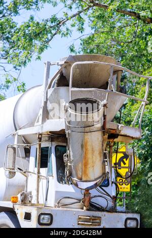 Mixer truck is cement to pouring fresh concrete into in housing development Stock Photo