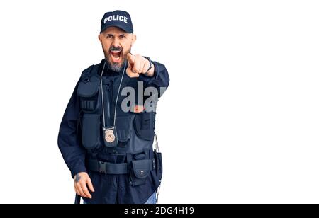 Young handsome man wearing police uniform pointing displeased and frustrated to the camera, angry and furious with you Stock Photo