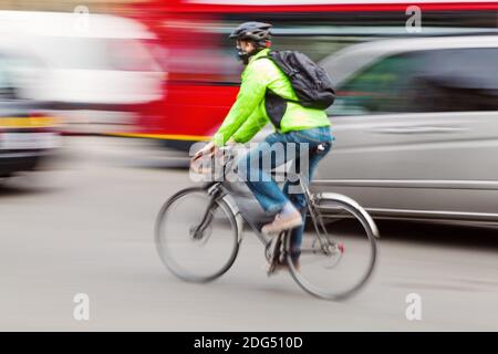 bicycle rider in city traffic with camera motion blur effect Stock ...