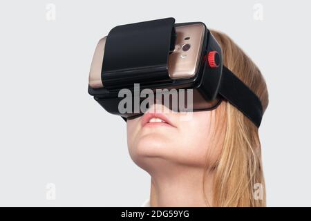Young woman entertaining with VR-Helmet Stock Photo