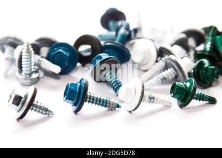 Screws of metallic, white, blue and green colors mixed on white background Stock Photo