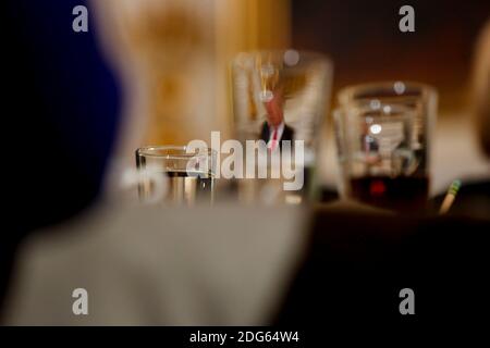 Attendees listen while U.S. President Donald Trump, seen through glasses, speaks at the National Governors Association meeting in the State Dining Room of the White House, Washington, DC, February 27, 2017. (Pool / Aude Guerrucci) Stock Photo