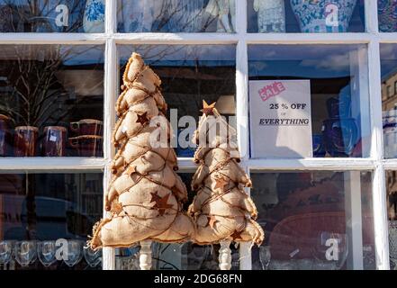 Interesting hristmas trees on display: Two burlap Christmas trees made using fabric sac and decorated with lights, stars , leaves and accorns are disp Stock Photo