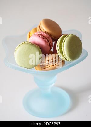 Colored French cookies in a blue flower shaped cup Stock Photo