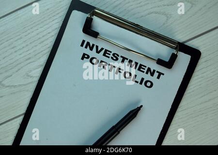 Investment Portfolio write on a paperwork isolated on Wooden Table. Stock Photo