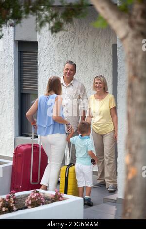 Mother and son arriving at parents house Stock Photo