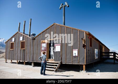 Woman reads about the Block 14 mess hall at Manzanar Nat. Historic Site, a camp where Japanese Americans were interned in World War Two in California. Stock Photo