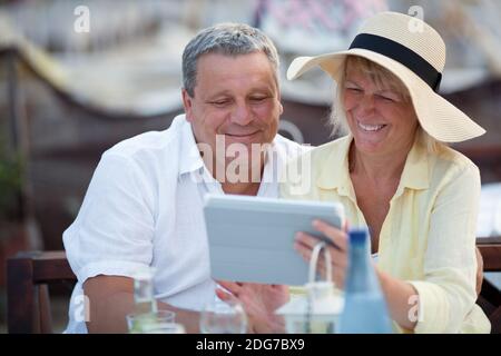 Smiling middle-aged couple using a tablet Stock Photo